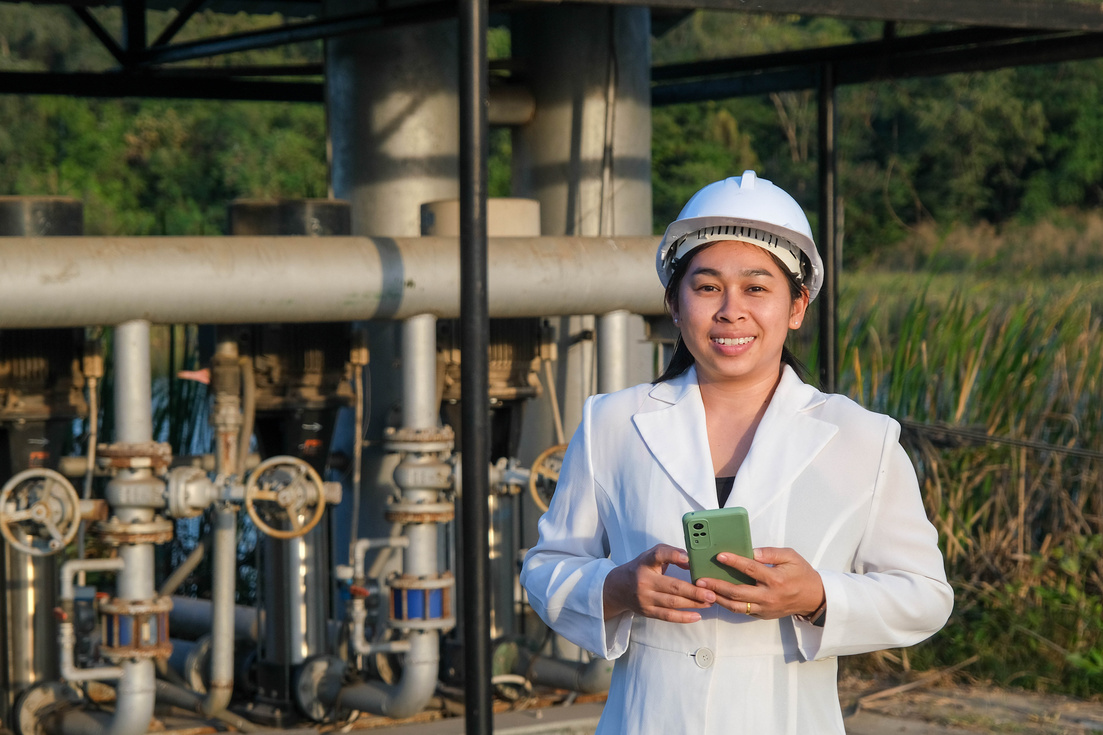 Environmental engineer in white helmet working at wastewater tre